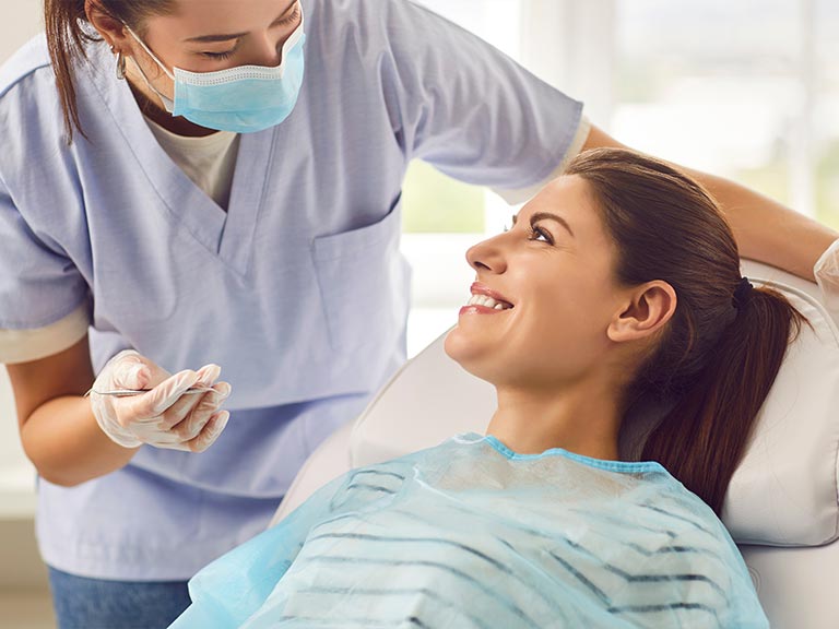 Friendly receptionist helping patient at frontdesk of Foothill Dental Care in Livermore
