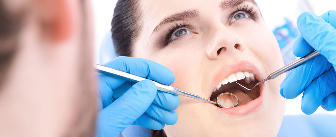Women getting dental exam in Livermore