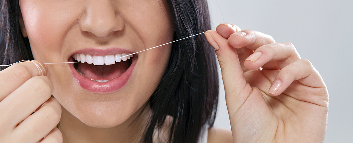 Woman flossing teeth at Foothill Dental Care in Livermore