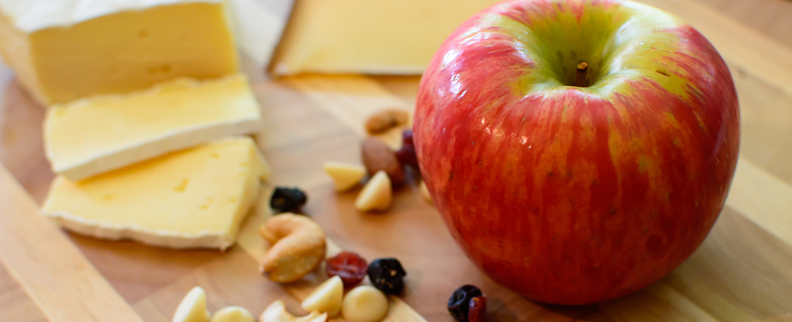 Chees, nuts and apple on a wooden table Foothill Dental Care in Livermore